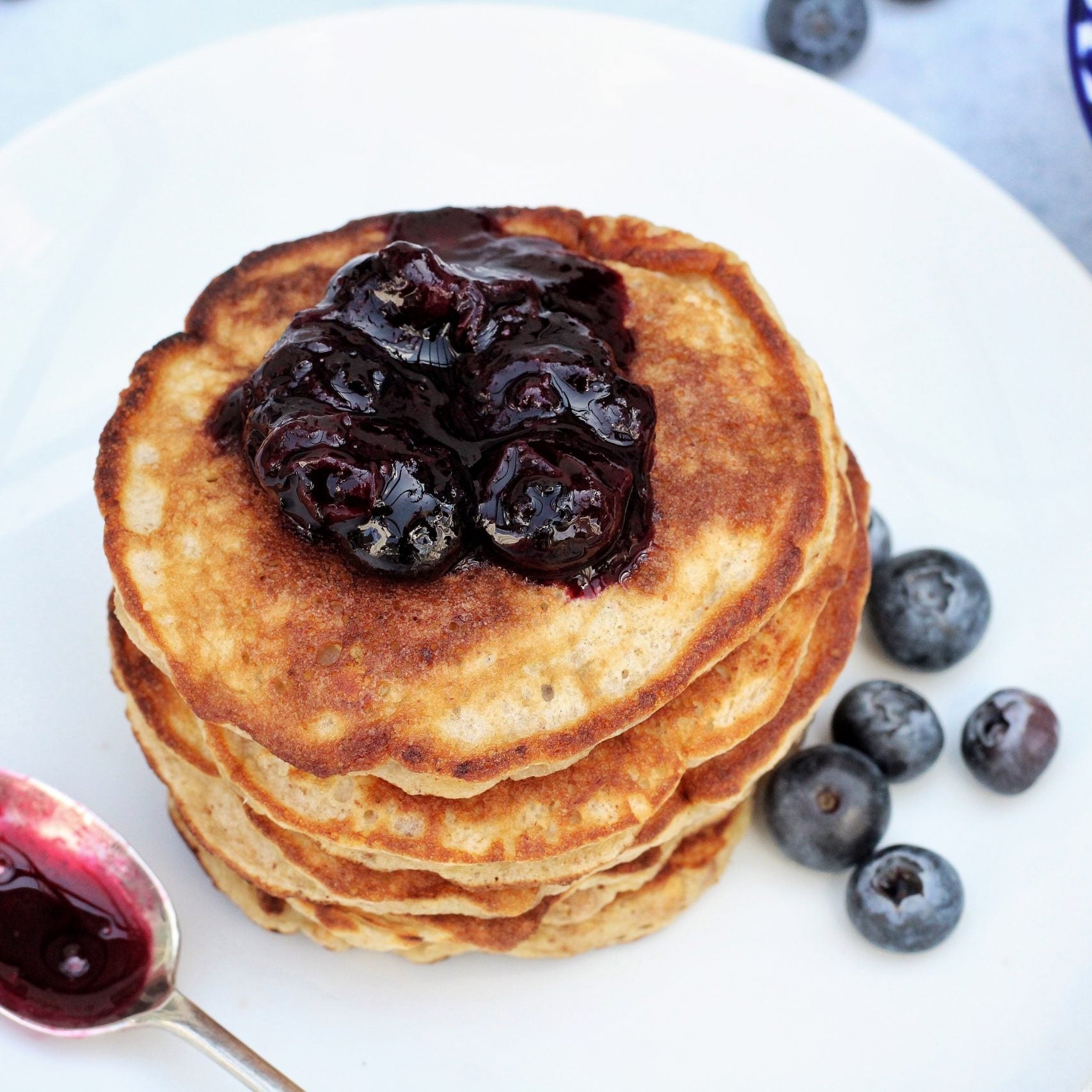 Banana and peanut butter pancakes with blueberry compote