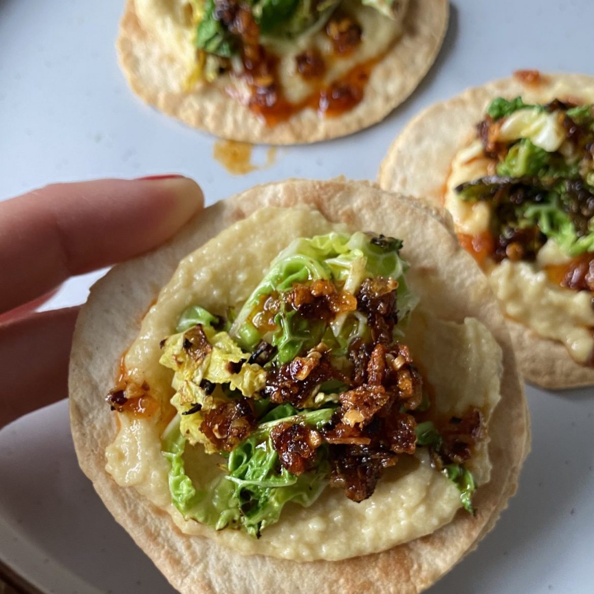 Smoky truffle hummus tostadas with charred cabbage
