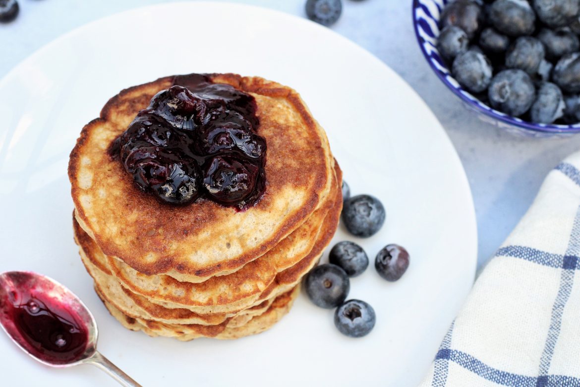 banana and peanut butter pancakes with blueberry compote